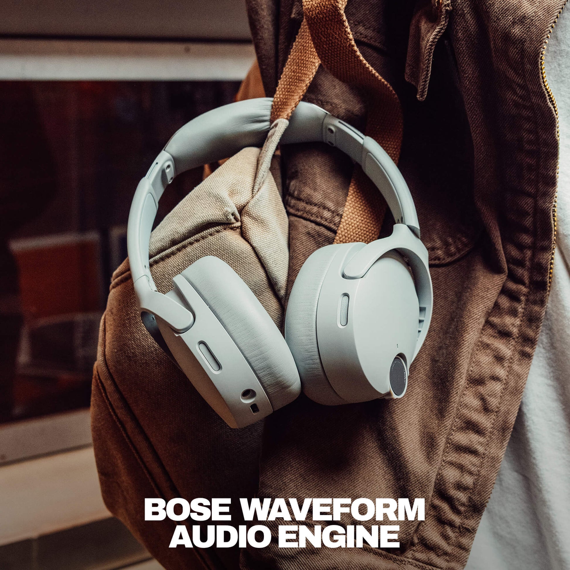 Skullcandy  Crusher 1080 headphones on a brown jacket with 'Bose Waveform Audio Engine' text. | Cement