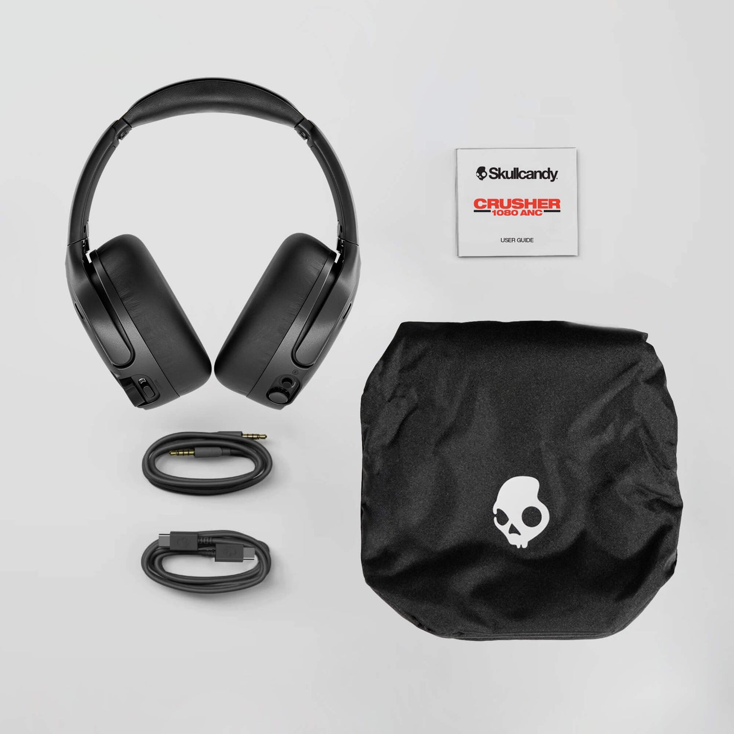 Black crusher 1080 ANC with accessories and Skullcandy logo on a light gray background | True Black