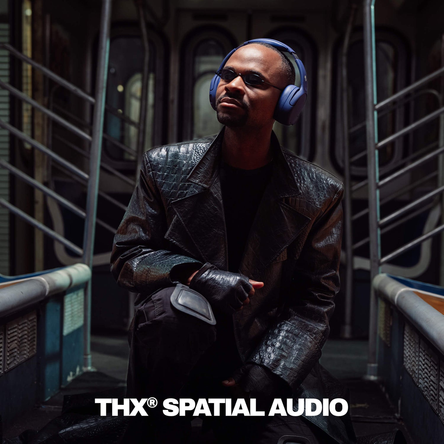 Person wearing Crusher 720 and a dark coat in a futuristic setting with 'THX Spatial Audio' branding.   | Future
