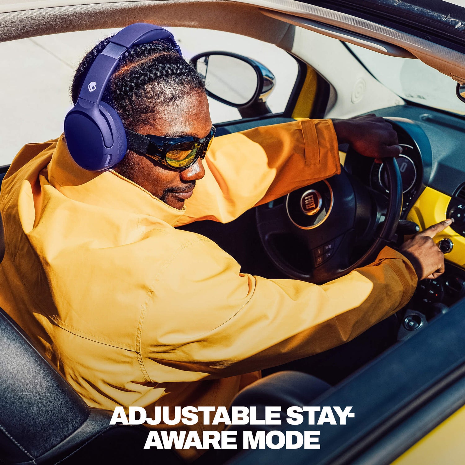 Person sitting in a car wearing Crusher 720 and sunglasses with text 'Adjustable Stay Aware Mode'. | Future