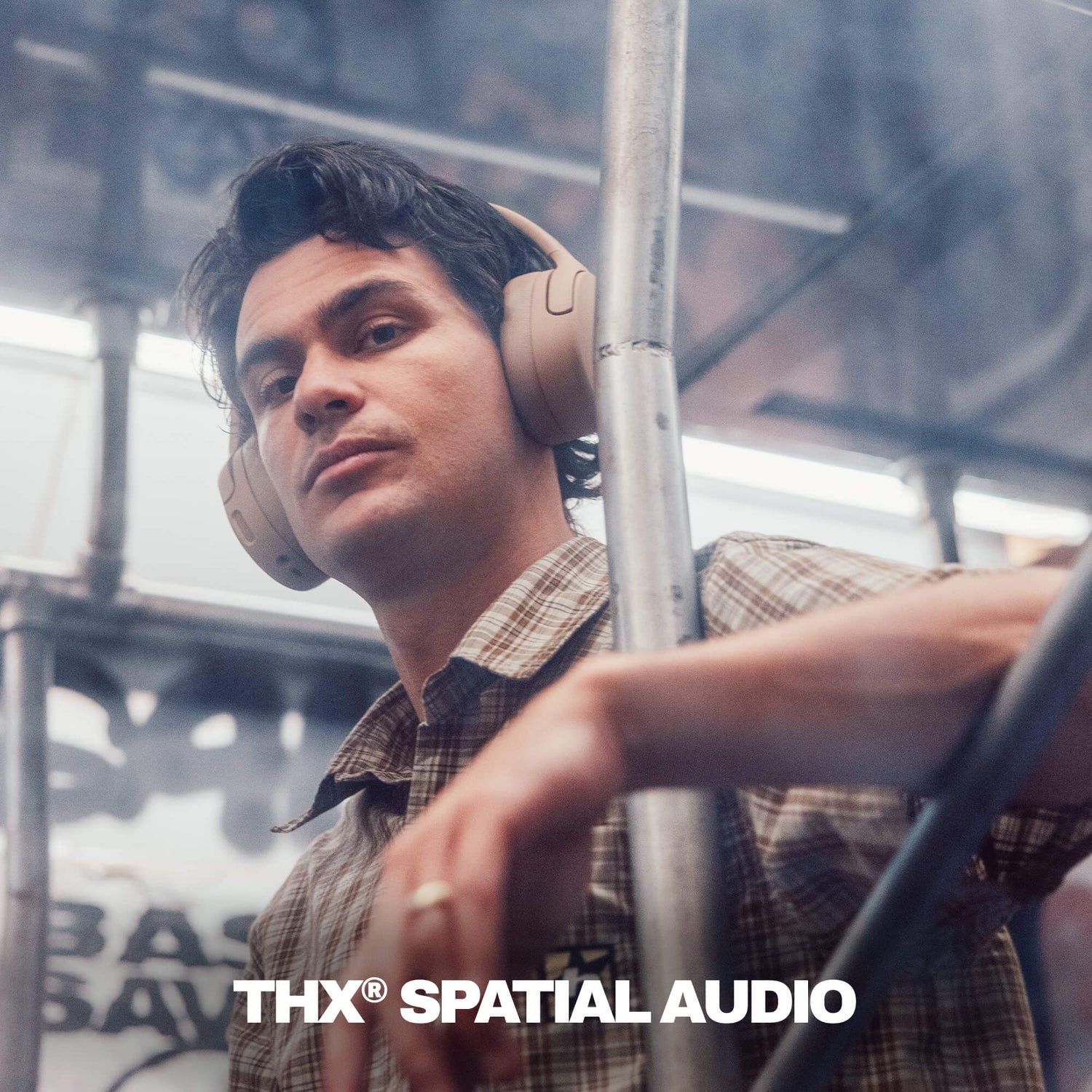 Person wearing Crusher 720 headphones with 'THX Spatial Audio' branding in a blurred urban setting | Primer