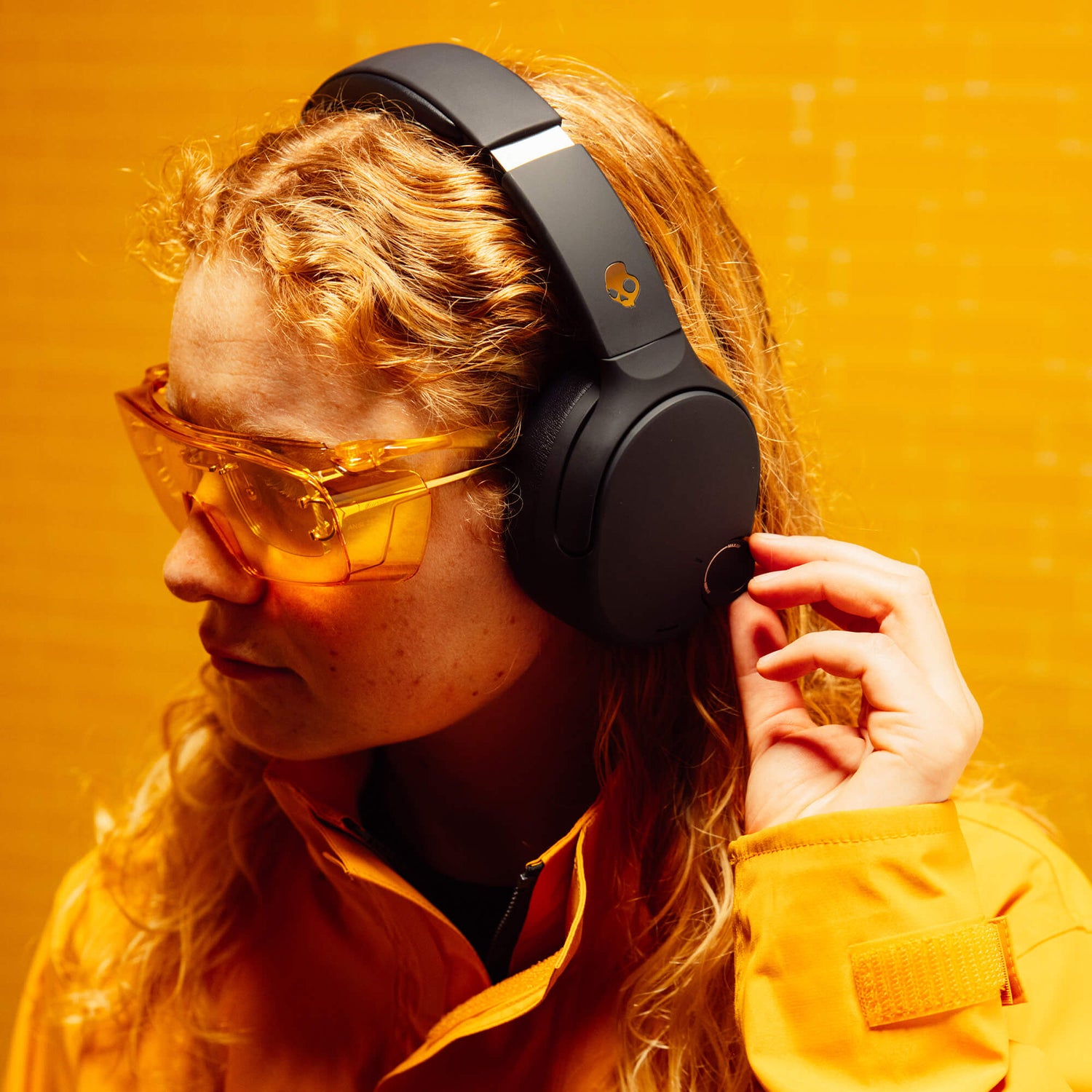 Person wearing black Crusher 720 and yellow sunglasses against a yellow background | True Black
