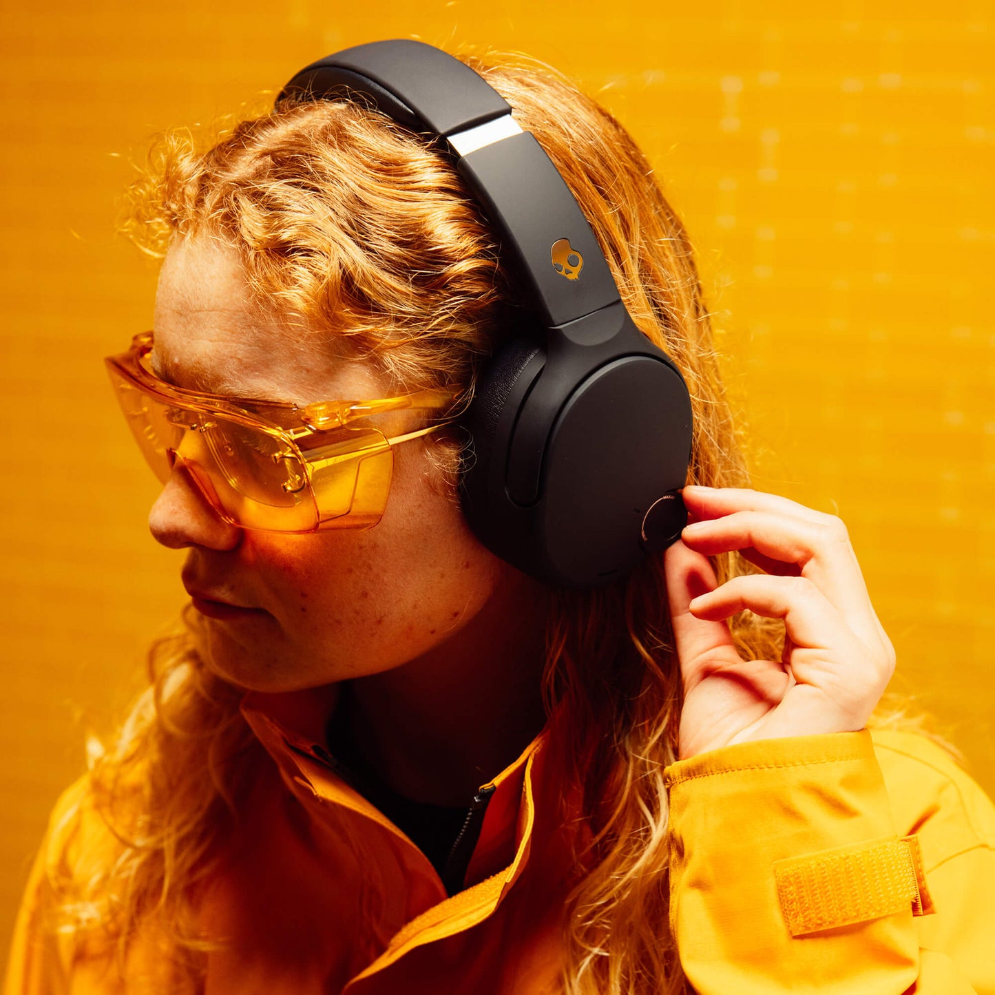 Person wearing black Crusher 720 and yellow sunglasses against a yellow background | True Black
