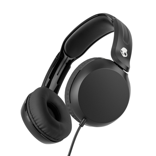 Black over-ear wired headphones with cushioned ear pads and a padded headband, shown at an angle on a solid black background. A small white skull logo is visible on the headband. | True Black