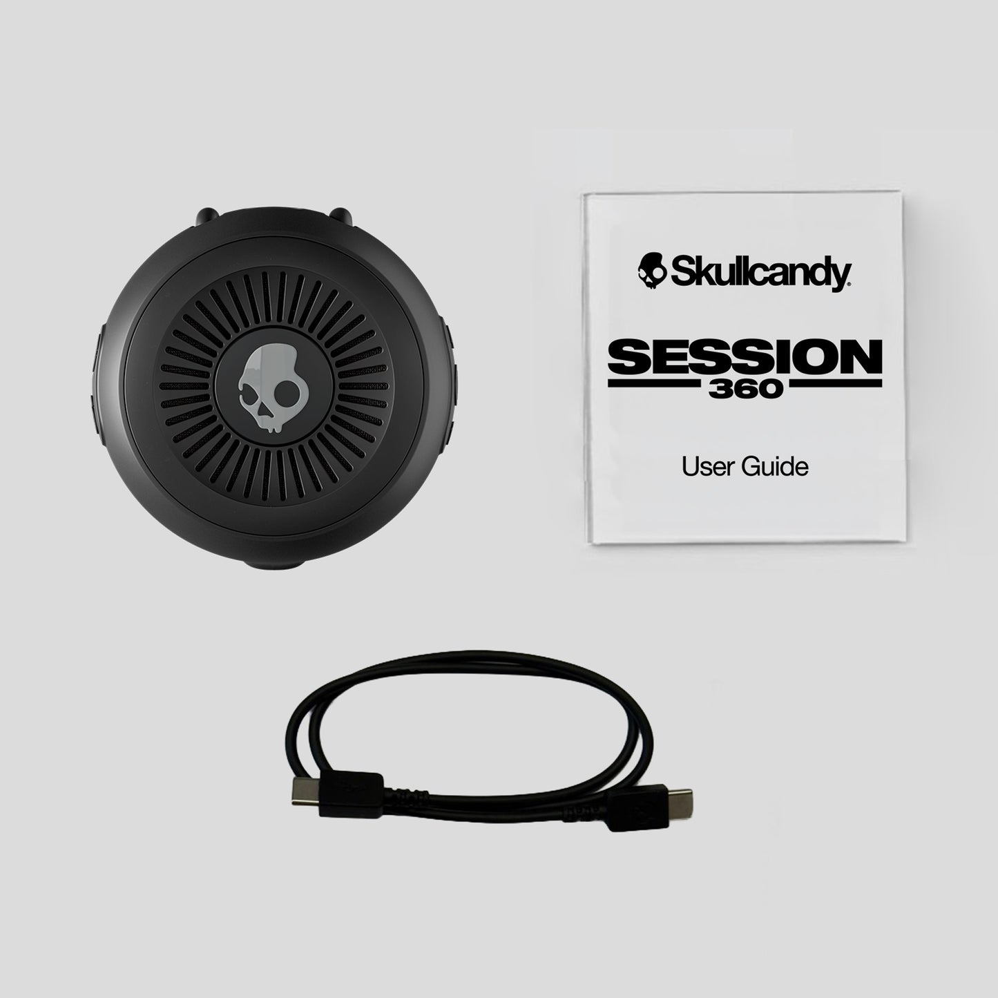 Skullcandy Session 360 headset with user guide on a light gray background | Cement