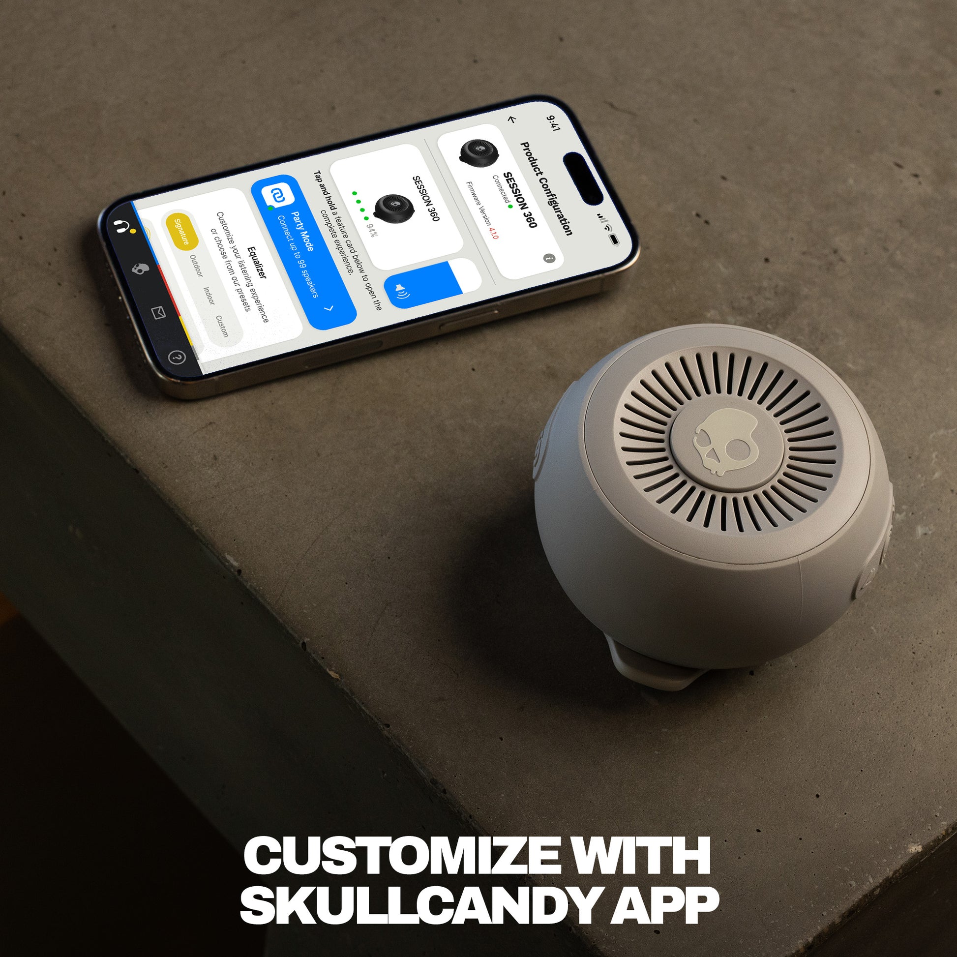 Smartphone displaying an app interface next to a speaker on a concrete surface with text 'Customize with Skullcandy App'. | Cement