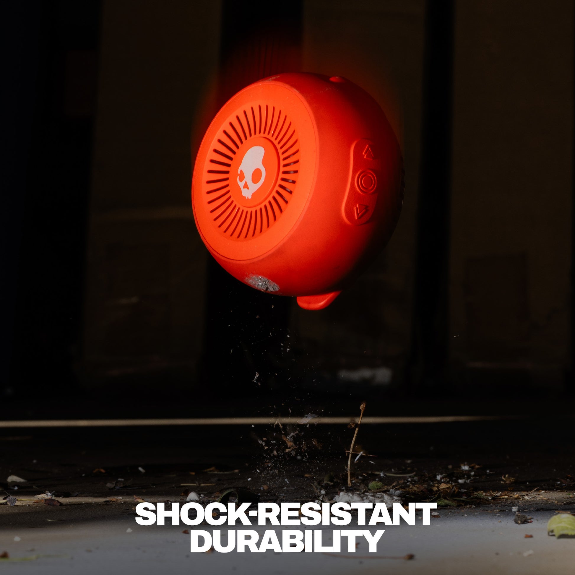 Orange shock-resistant speaker with durability text on a dark background | Plasma