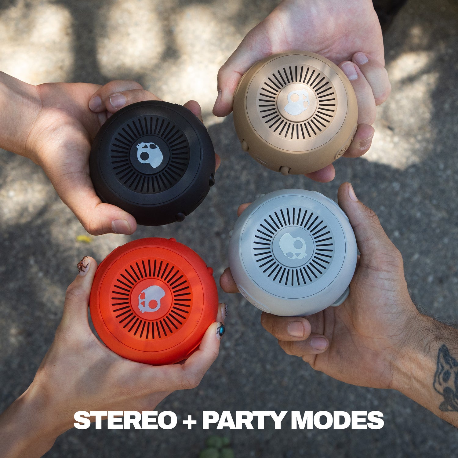 Four hands holding different colored round speakers with 'STEREO + PARTY MODES' text. | Plasma