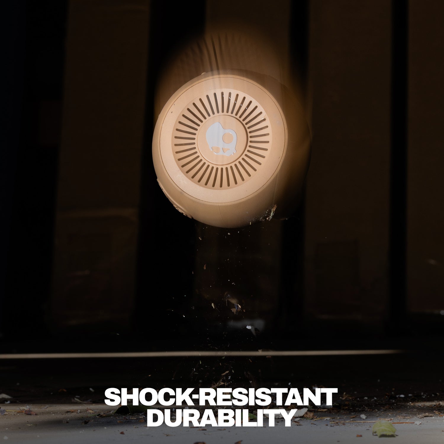 Round shockproof speaker with 'Shock-Resistant Durability' text on a dark background | Primer