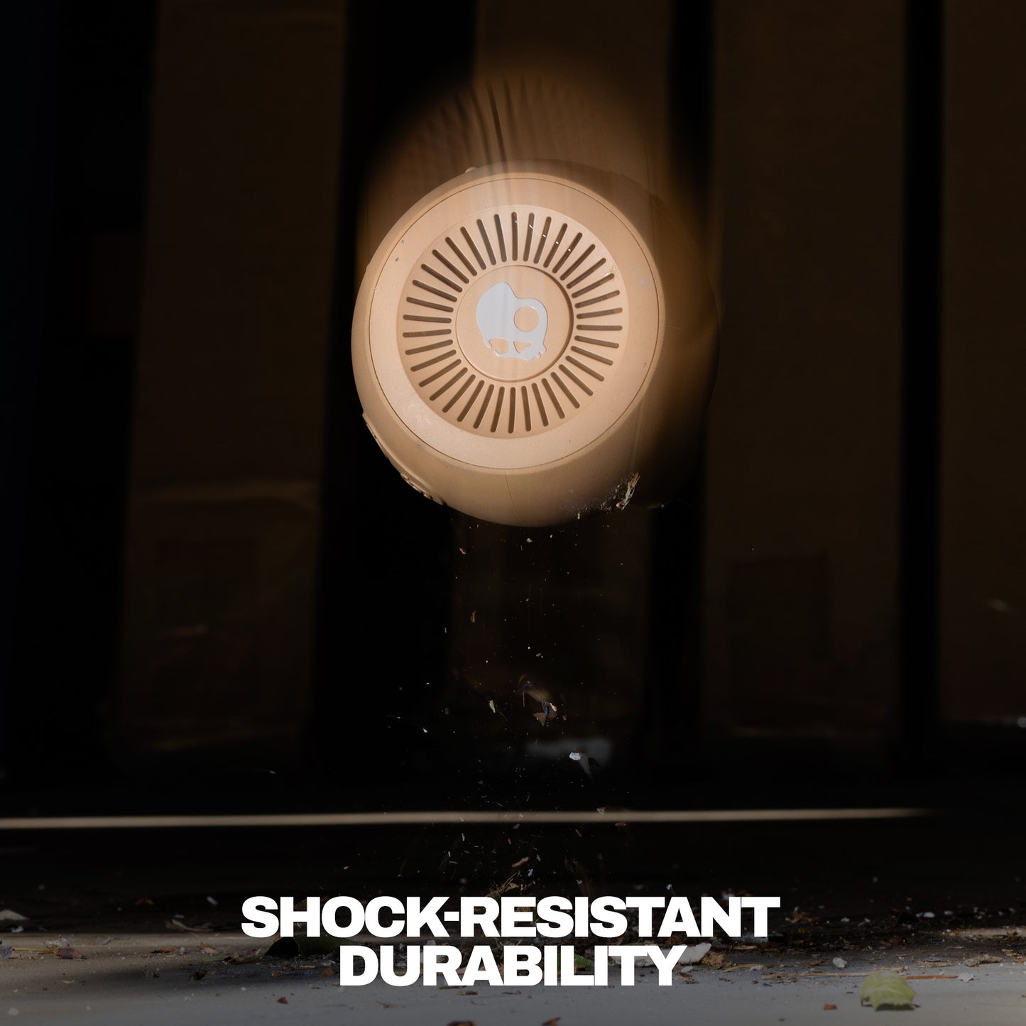 Round shockproof speaker with 'Shock-Resistant Durability' text on a dark background | Primer