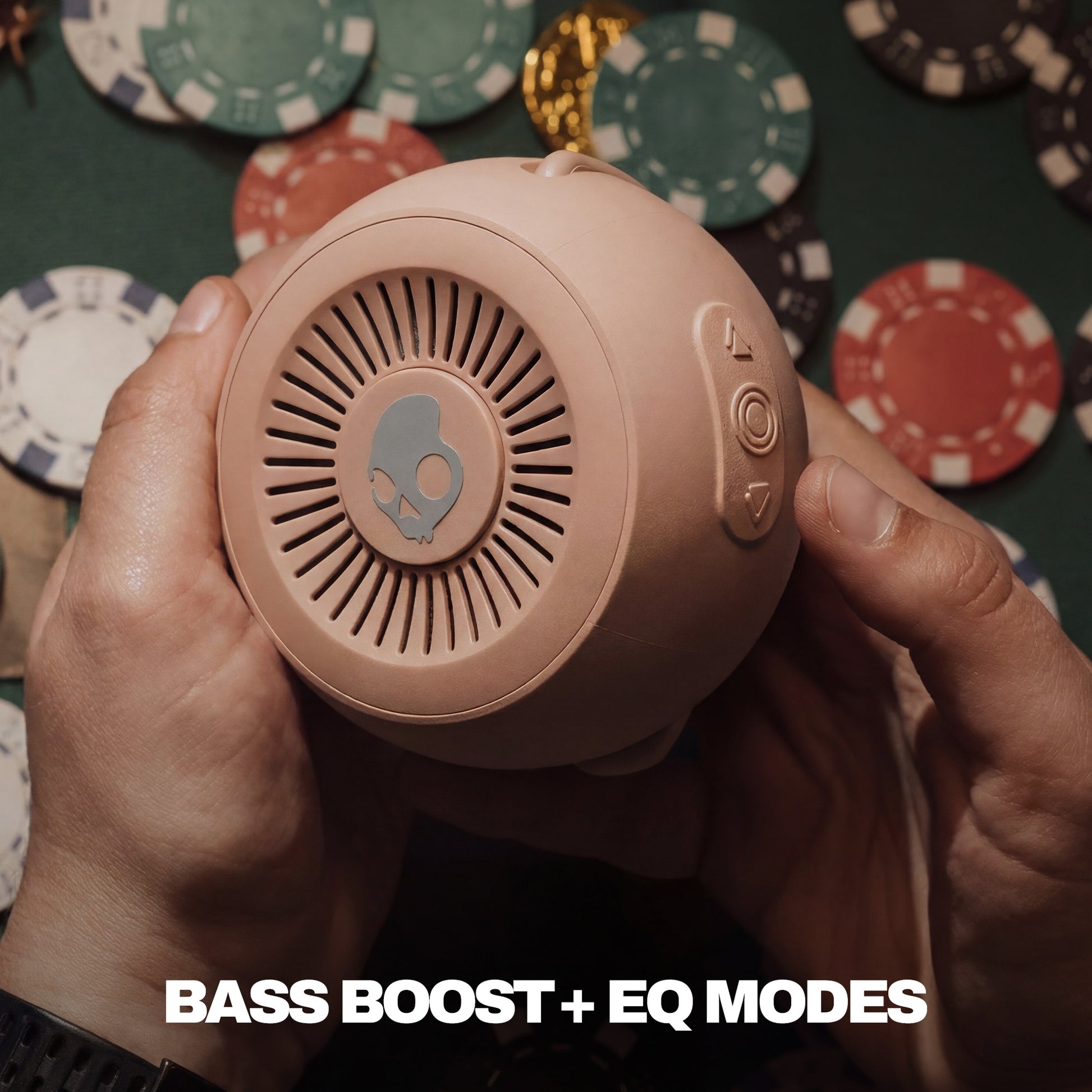 Person holding a pink speaker with poker chips in the background | Primer
