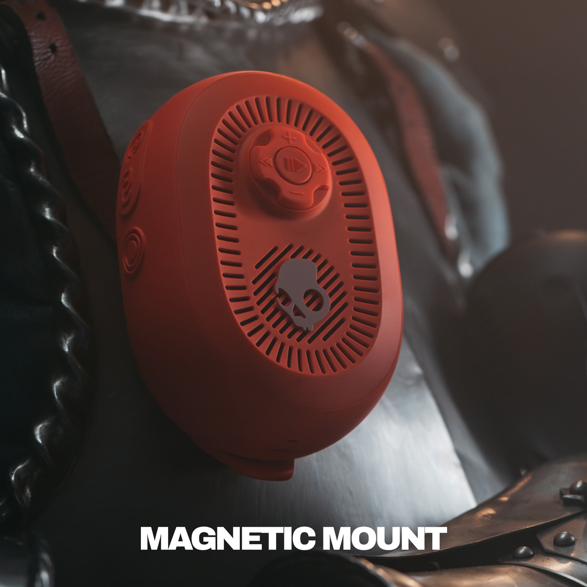 Red magnetic speaker on a motorcycle seat with 'MAGNETIC MOUNT' text. | Plasma