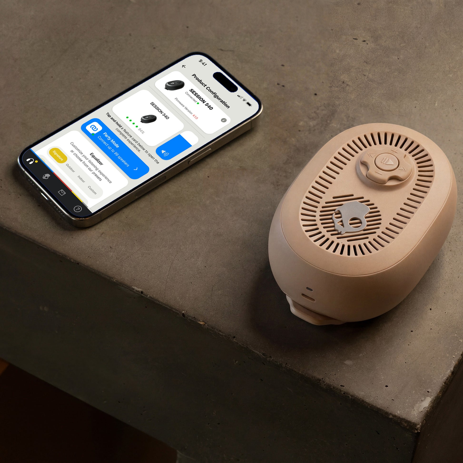 phone with app interface next to a cylindrical beige speaker on a concrete surface | Primer